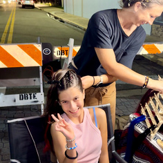 Picture of a girl on vacation getting a dutch braid hairstyle in daytona beach