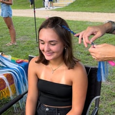 kid getting a single braid