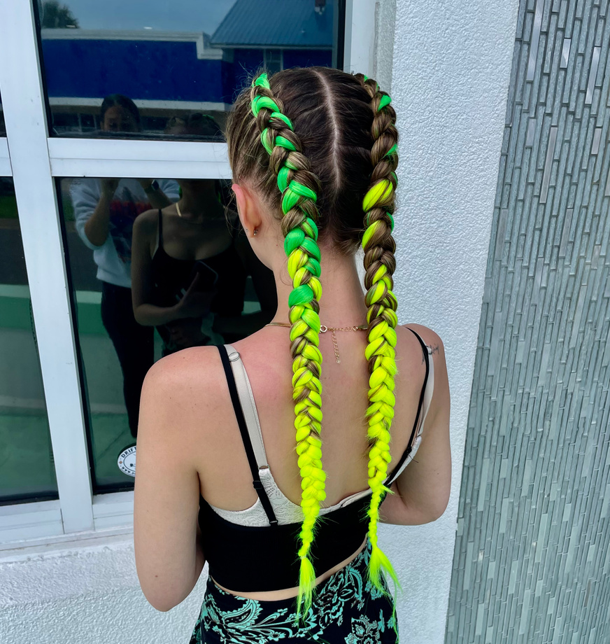 young girl with green and yellow french braids in their hairstyle in daytona beach