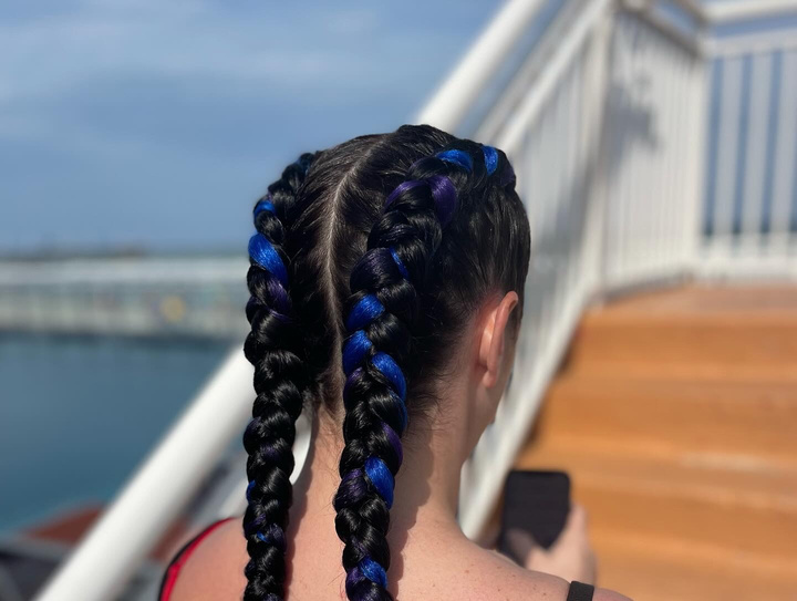 a person with colorful blue and black french braids on their hair in ormond beach